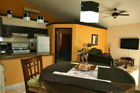 VIEW OF THE KITCHEN AND DINING ROOM IN THE HOUSE FOR SALE AT THE CLUB AND RESORT FOR SALE, PANAMA